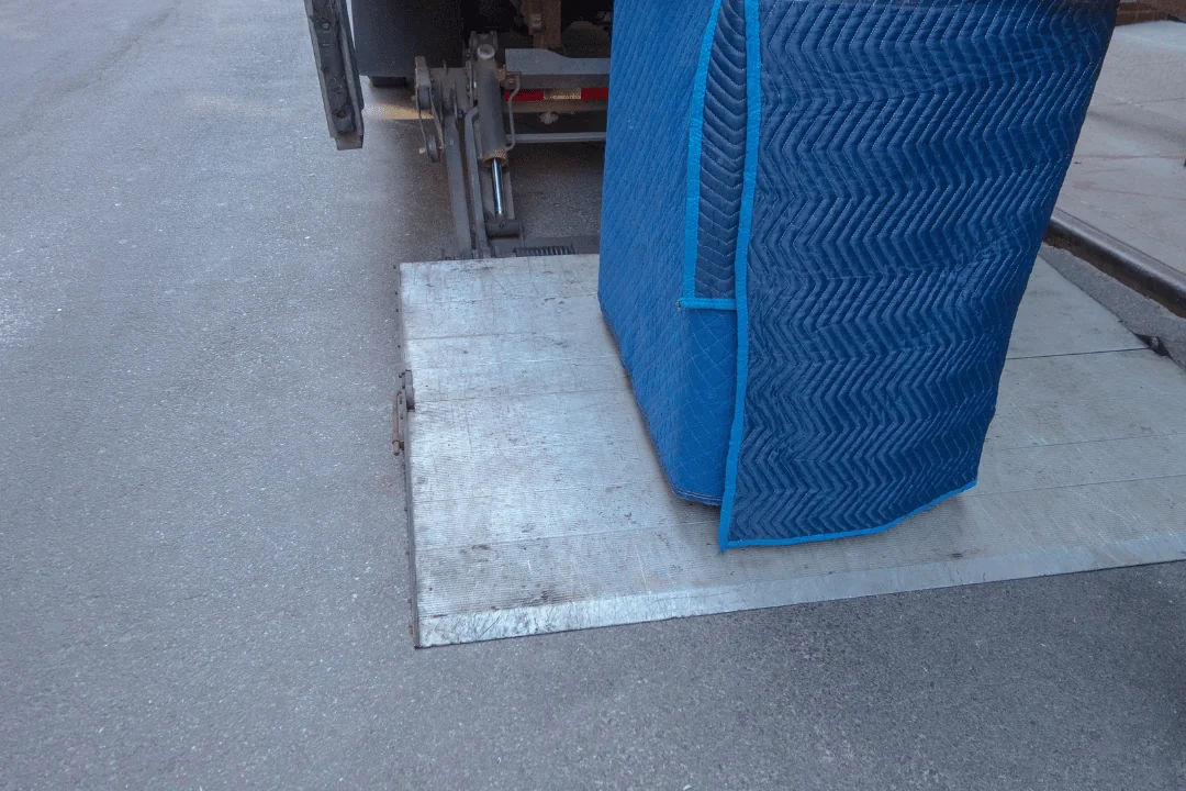 Blanket Wrap blanket wrapped item being lifted by lift gate onto truck