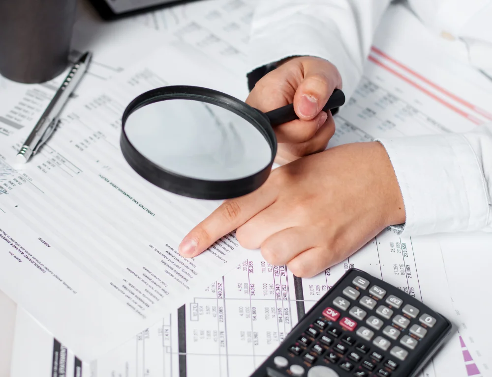 Freight-Bill-Audit-hand-pointing-at-bill-with-magnifying-glass