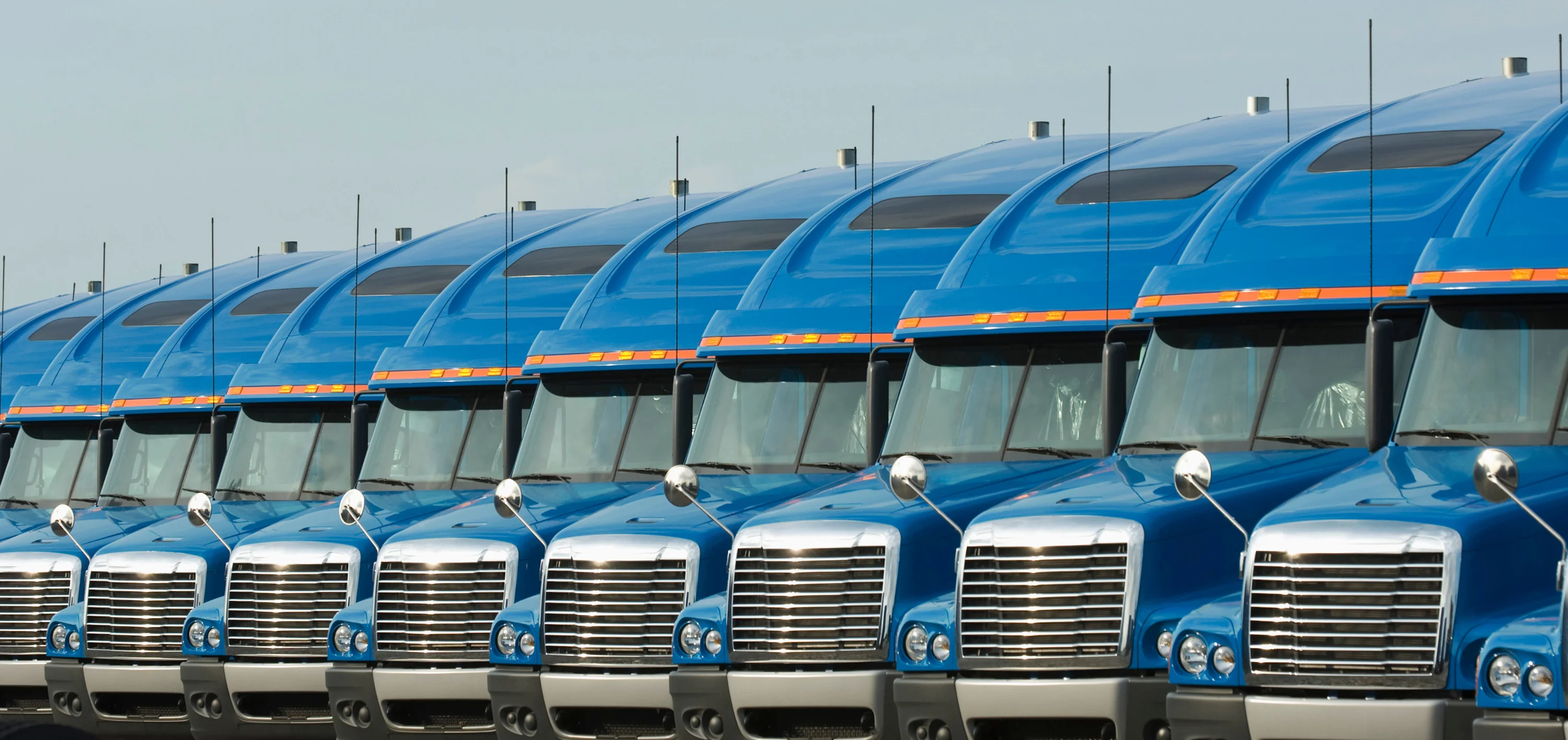 Load Board vs Freight Marketplace row of blue semi trucks