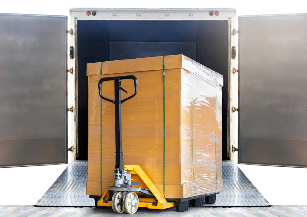 cargo on a pallet jack sitting on a semi trucks lift gate